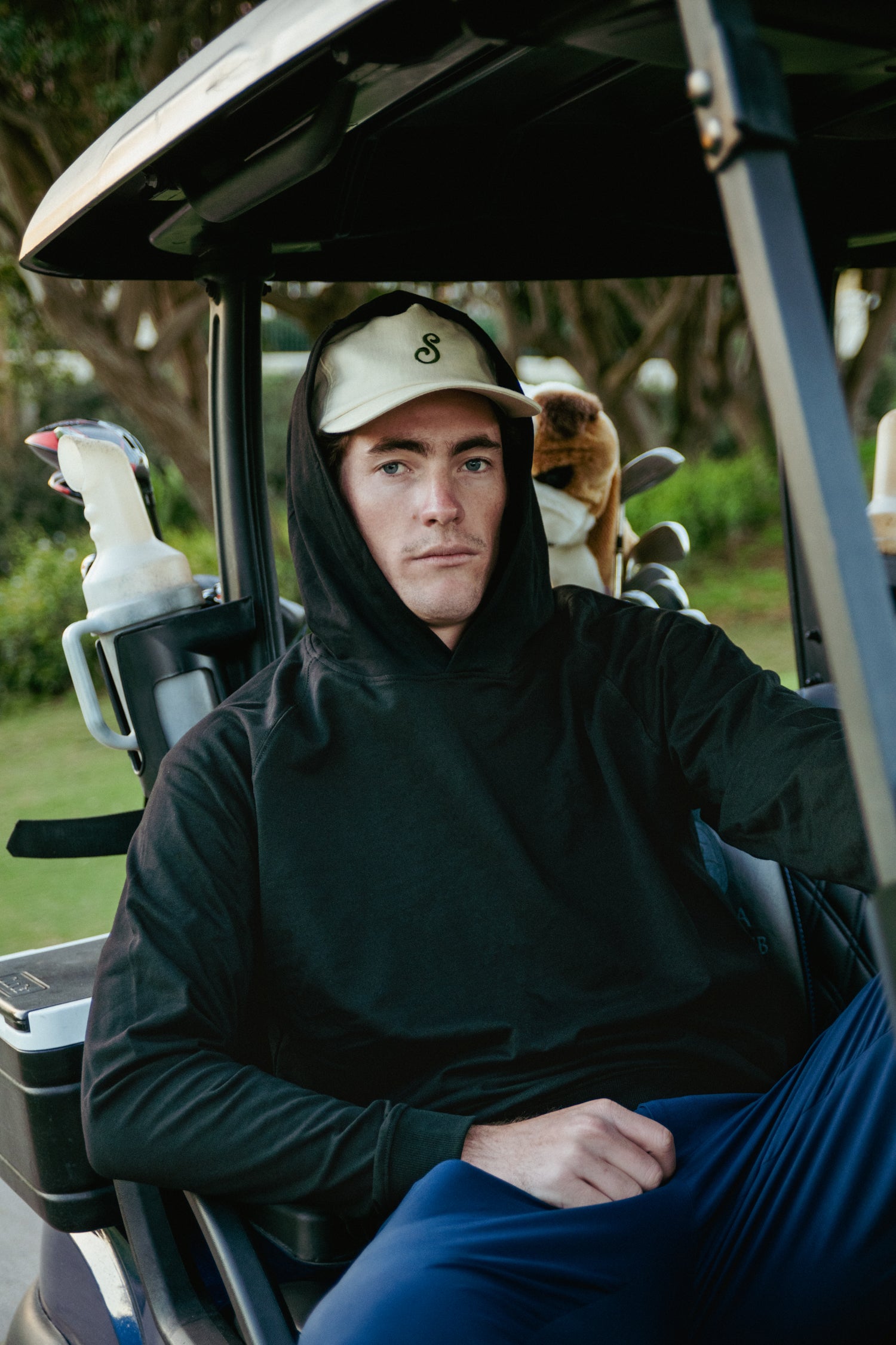 Man sitting in a golf cart on a golf course