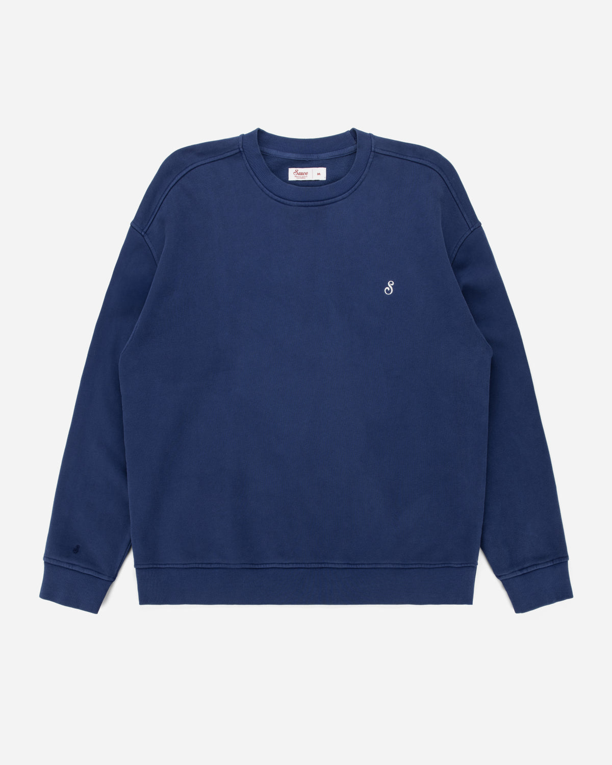 A navy blue crewneck sweatshirt with a small white embroidered logo on the left chest, displayed flat against a light gray background.