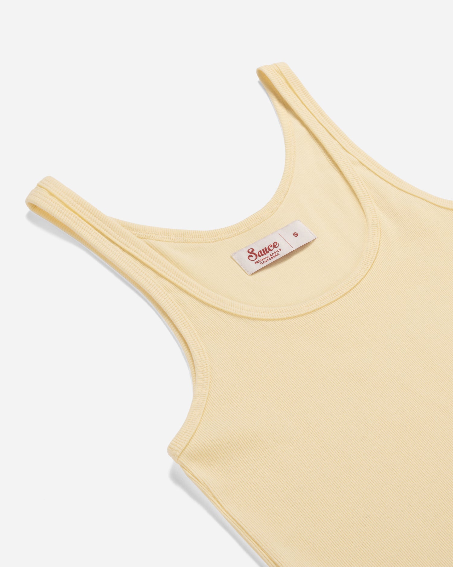 Yellow tank top with a brand label on a white background