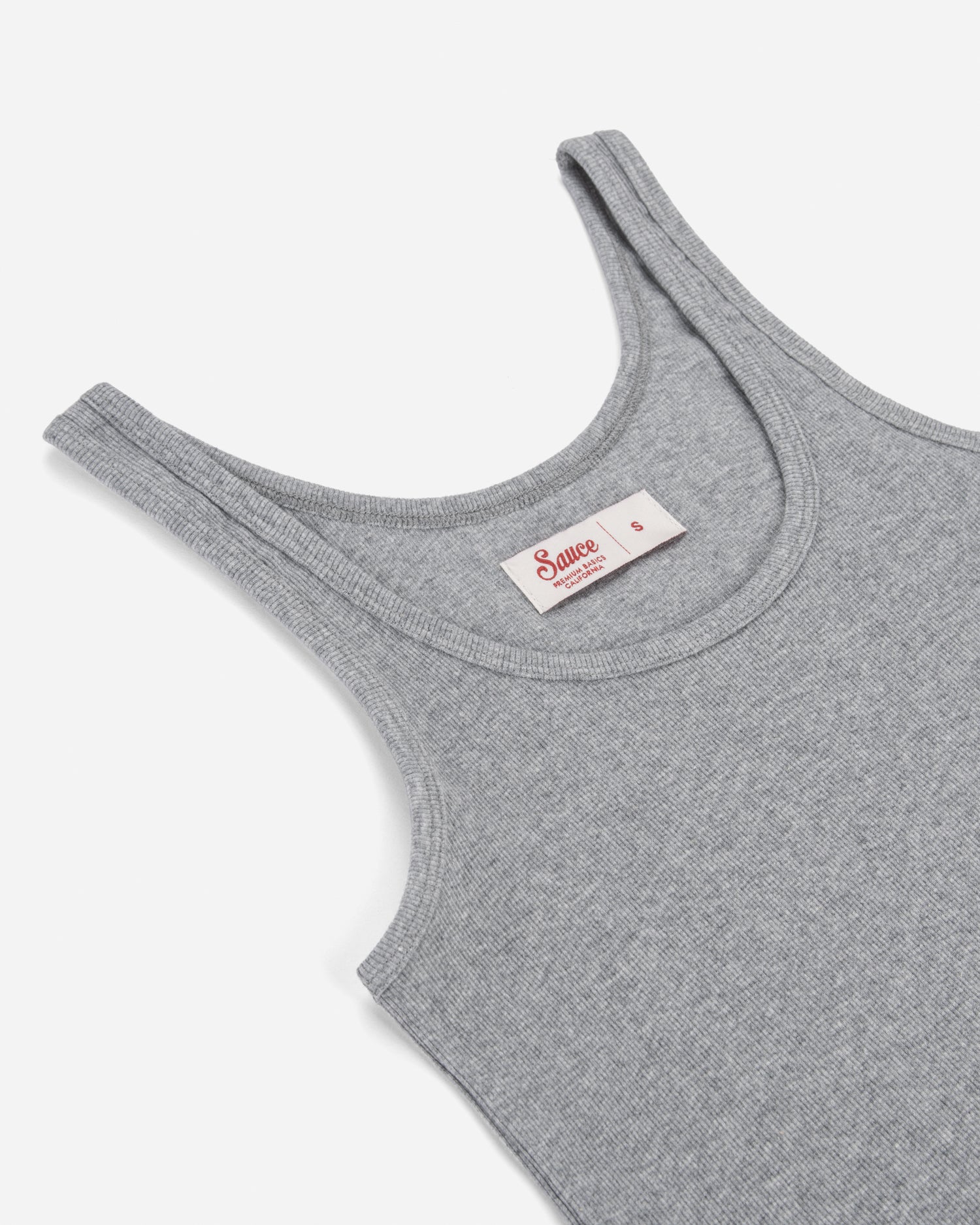 Gray tank top with a brand label on a white background