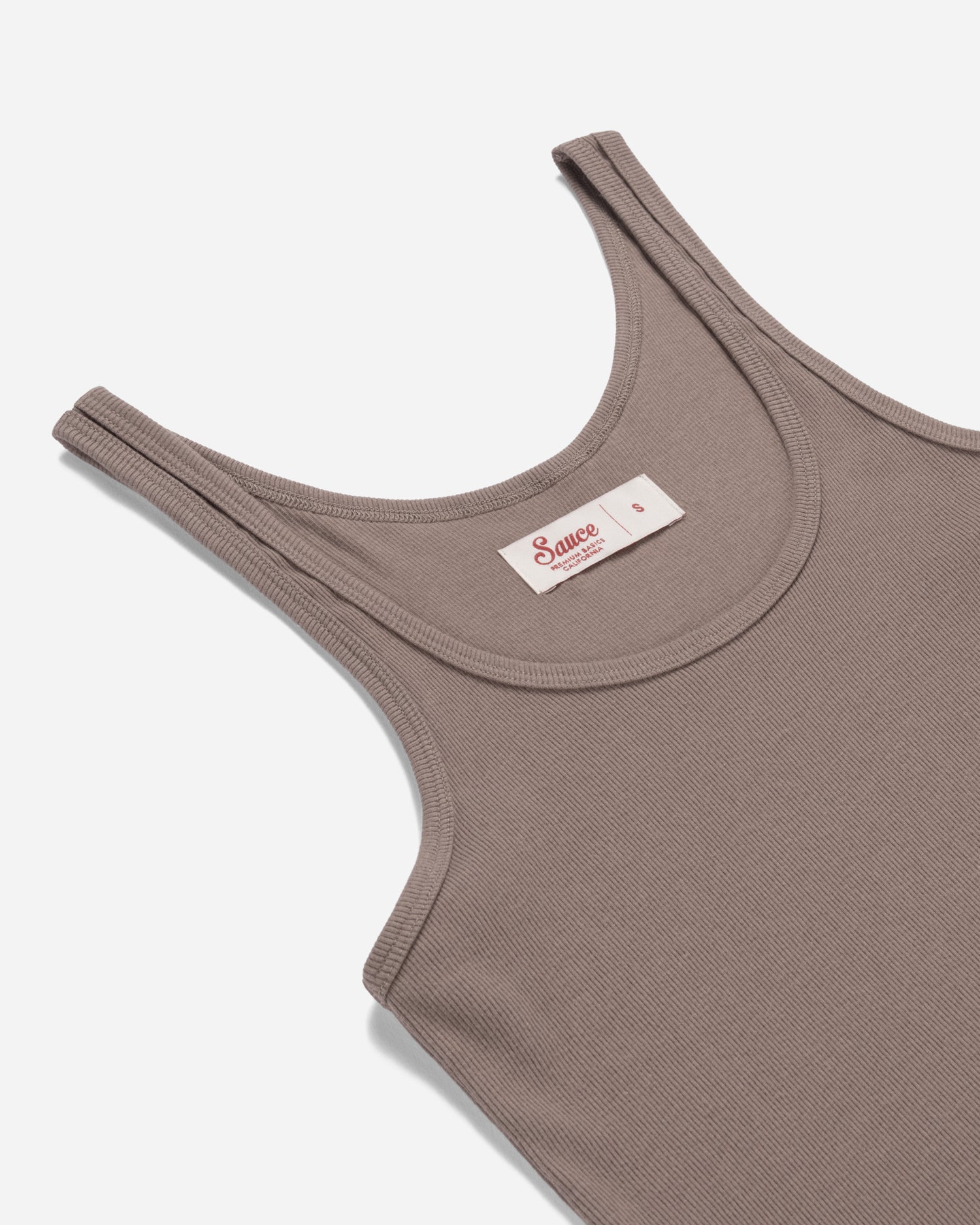 Brown tank top with a visible brand label on a white background