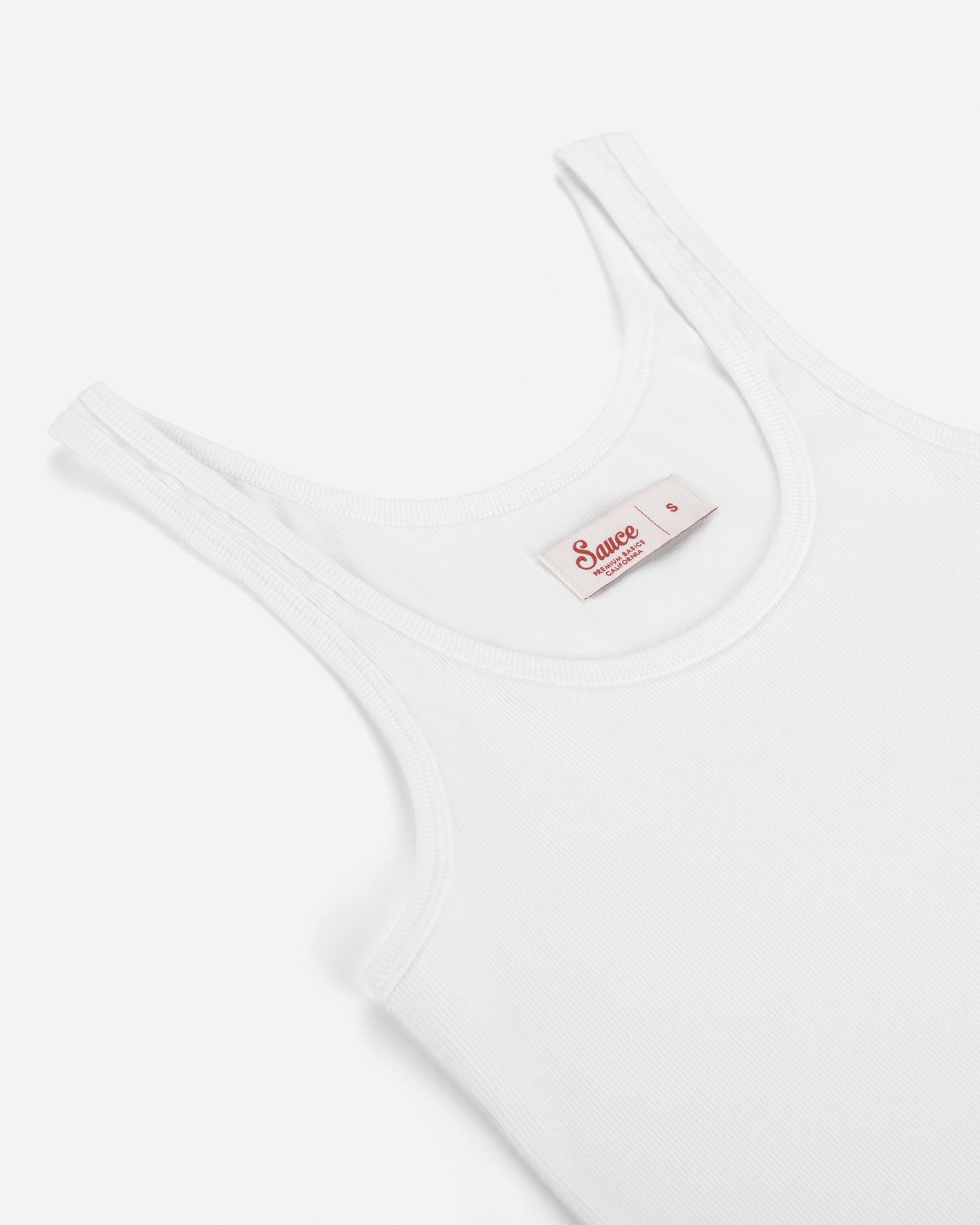 White tank top with a brand label on a white background