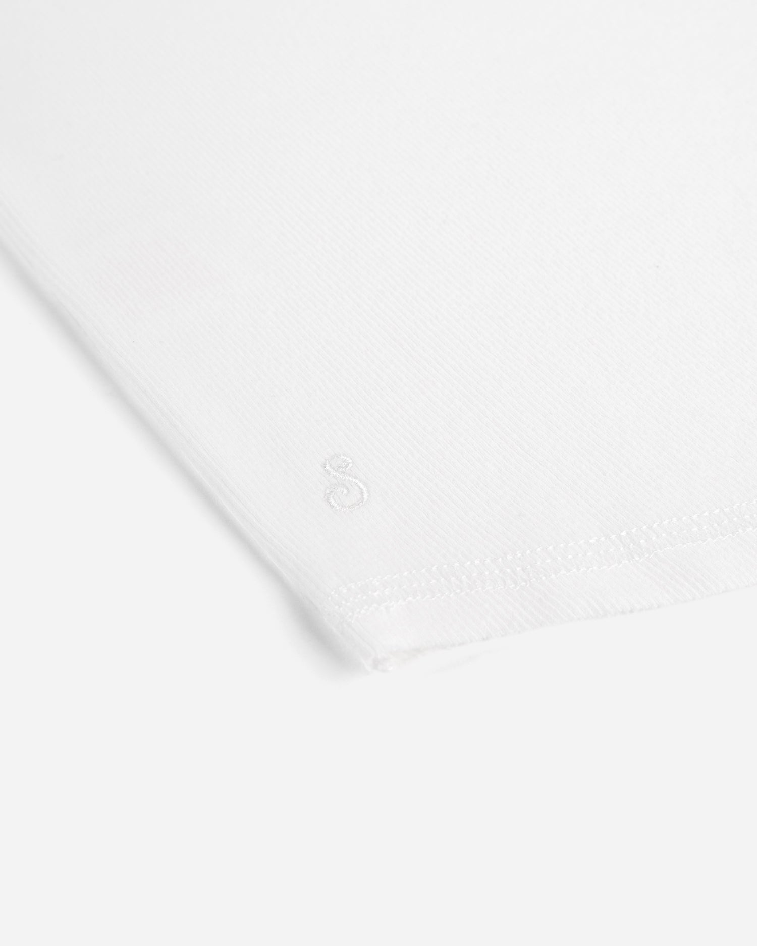 White fabric with a subtle pattern on a white background