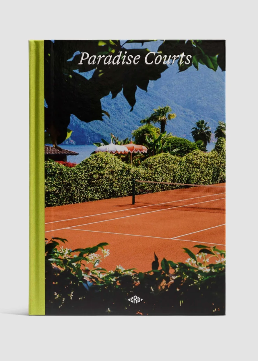 A hardcover book titled 'Paradise Courts' standing upright against a light gray background. The cover features a photograph of a clay tennis court with lush greenery and mountains in the background, and a bright lime green spine.