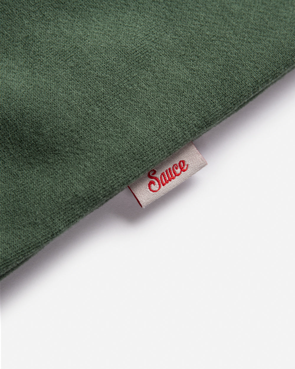 Green fabric with a visible label on a white background