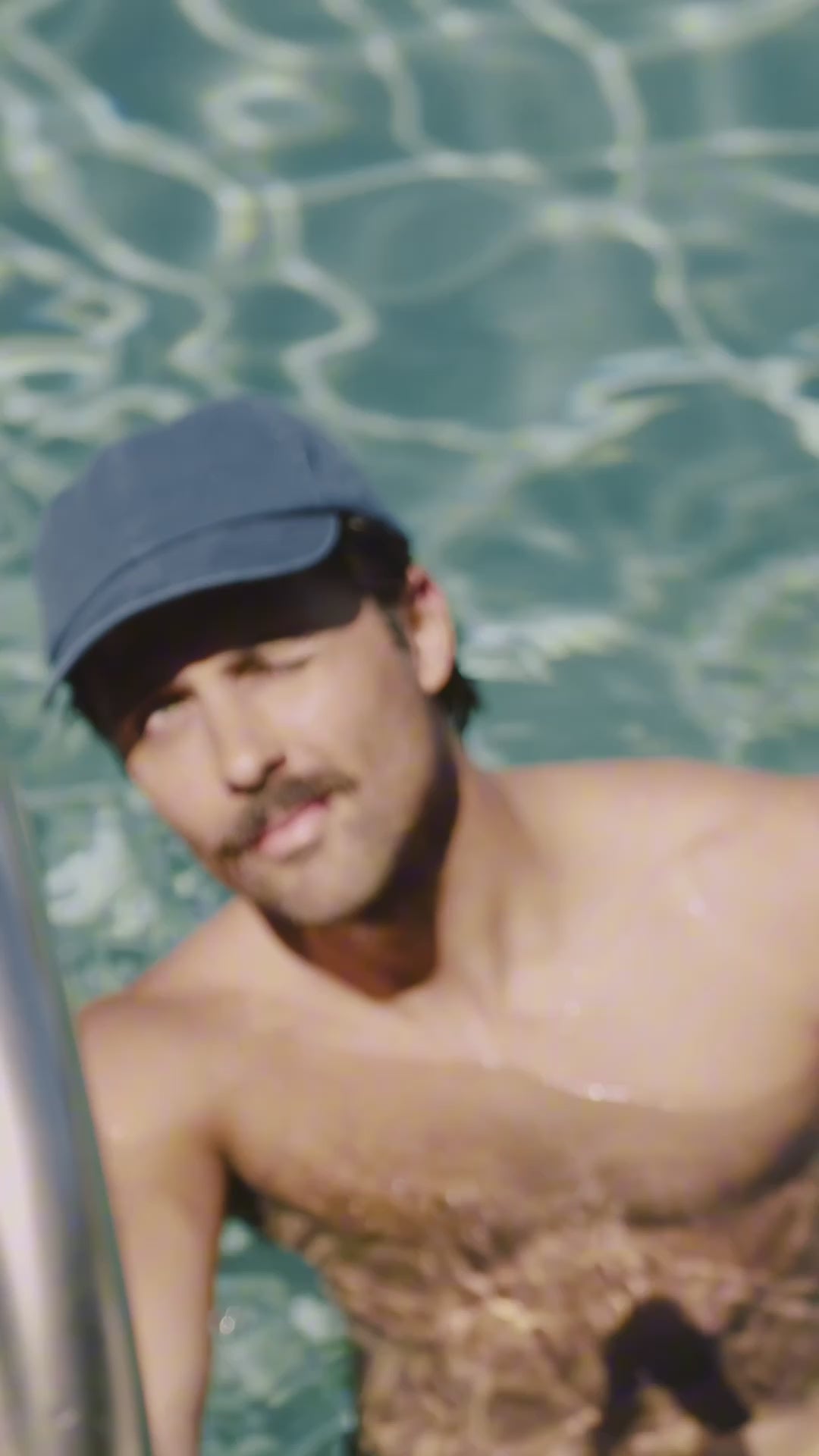 Person wearing navy cap in pool