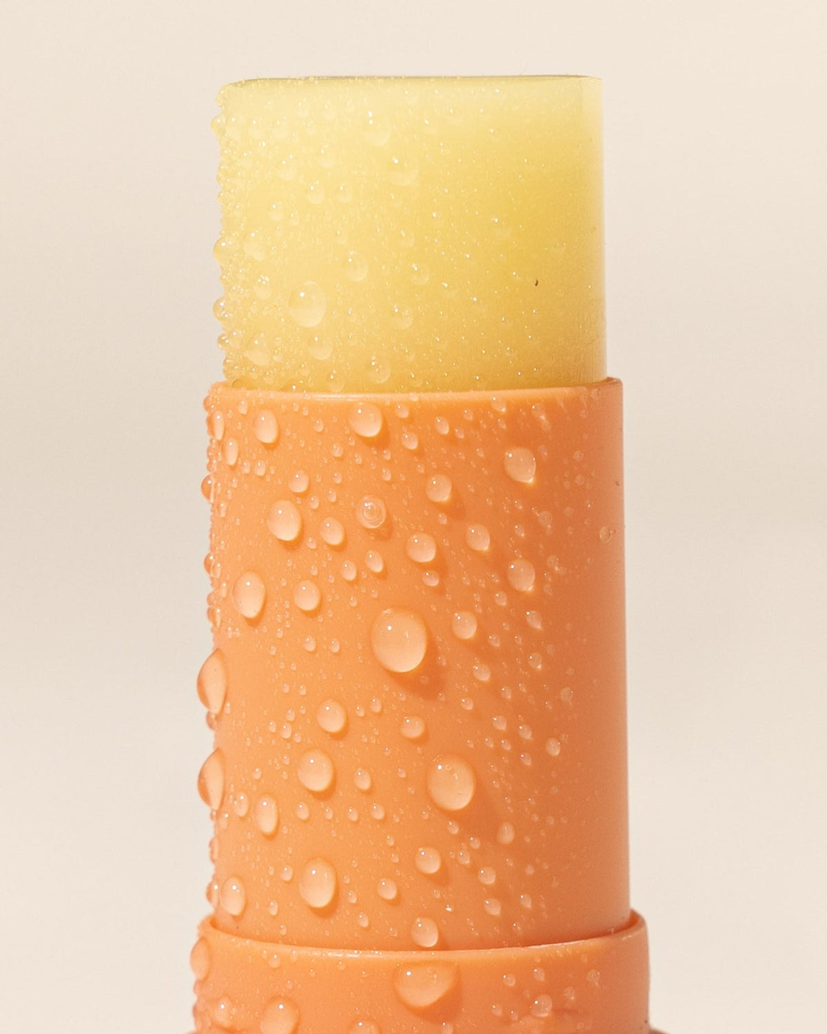 Sensitive lip balm with SPF50+ with droplets of water on tube